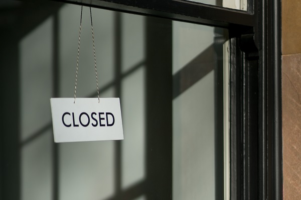 A sign saying closed in an office window