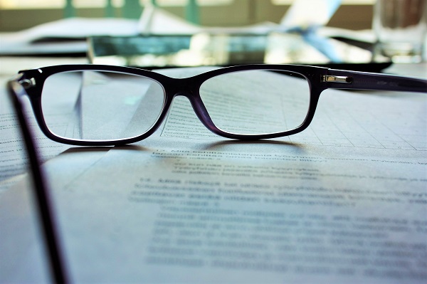 A pair of glasses on top of a business document