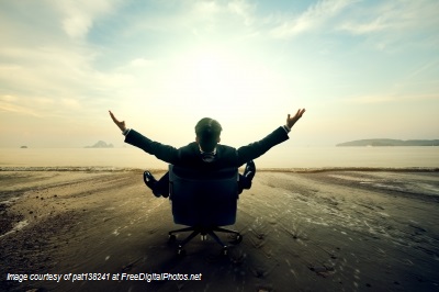 Person on a chair on the beach with their arms open