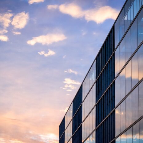 Pink and blue sunset with an office building made of glass
