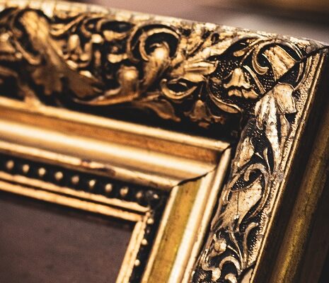 Close up corner of a gold picture frame with no picture in